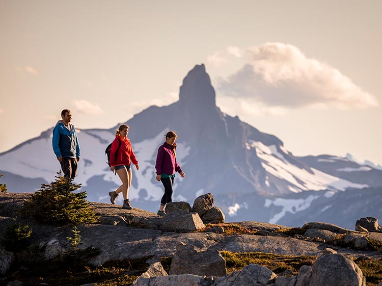 People hiking down Black Tusk in Garibaldi Provincial Park near Whistler British Columbia at dusk